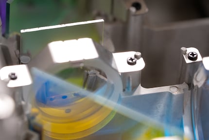Because the dichroic mirror is exposed, light can get to it from all sides and be split into its spectral components. This results in all kinds of colours shining around it even through no laser has been switched on. Blockbuster.
