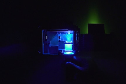 Here, I'm illuminating with blue light. On the right, you can see green coming out.