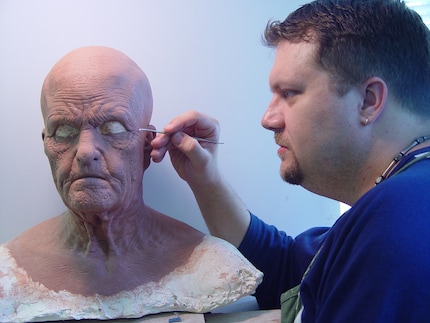Here, Lee's working on a full-head mask made up of multiple parts and aging make-up.