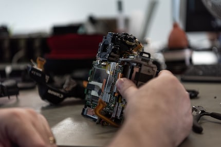 The mainboard is the metal part under the flexible cables.