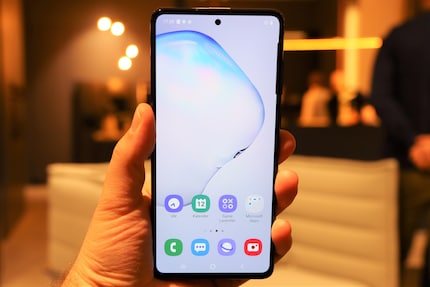 Large display with hole and fingerprint sensor.
