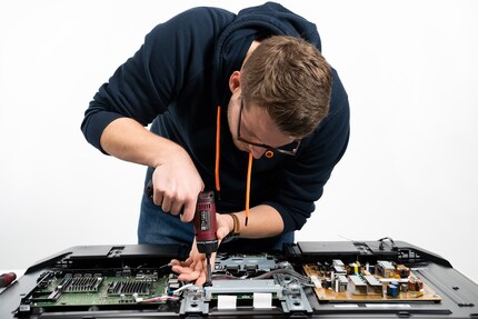 Unscrewing a TV.