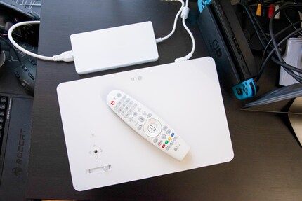 The projector's power supply is quite flat, but quite large. A remote control is also included with the device