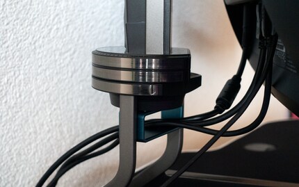 The hard plastic and metal stand also offers a cable management solution.