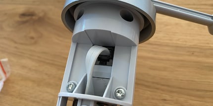 The cable is routed through the opening and placed in the slot.