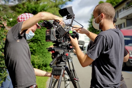 The camera operator and his aides.