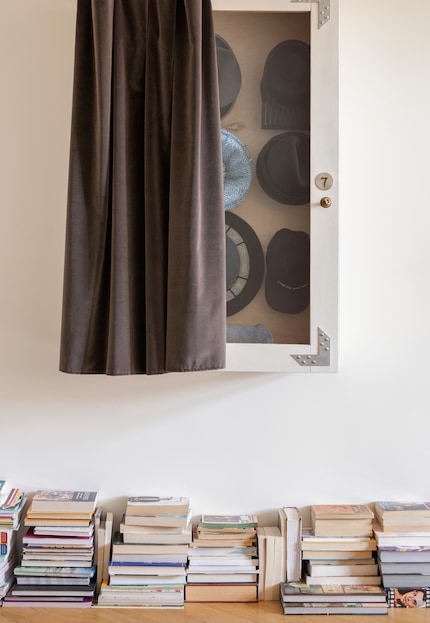 In front of a white wall, stacks of books with their backs to the wall are almost unnoticeable. Photo: Ferm Living