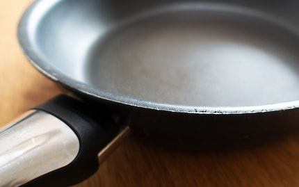 Hopefully the coating will continue to flake off only at the edge of the pan.