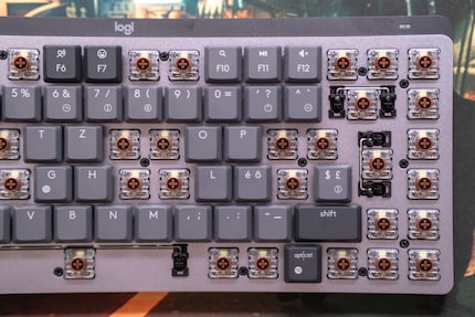 The screws you need to open up the keyboard are hidden under the keycaps.