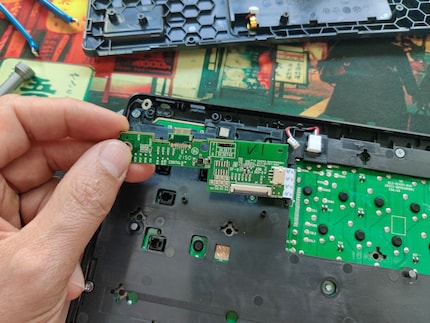 I had to detach the daughterboard before I could get to the circuit board.