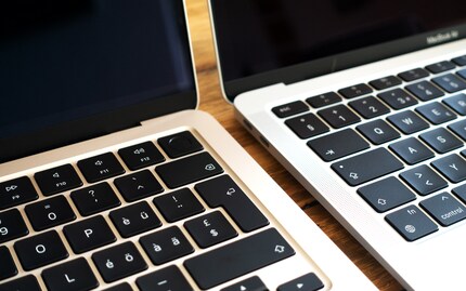 The M2 laptop on the left features invisible speakers.