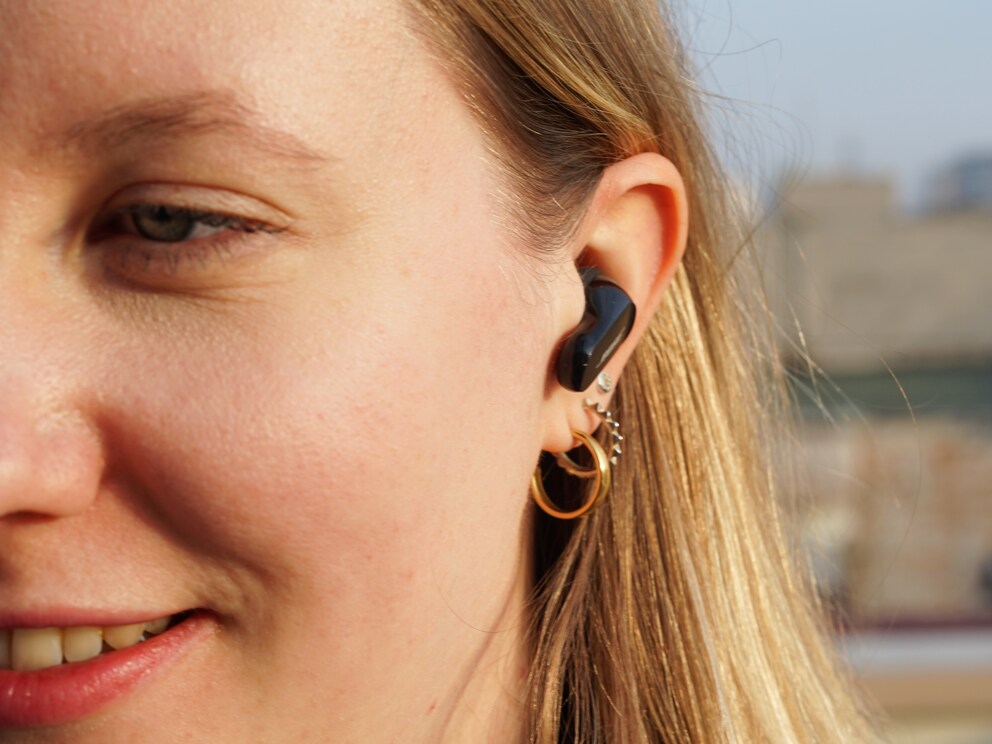 The QuietComfort Earbuds II protrude slightly from the ear, with their elongated shape creating a secret service vibe.