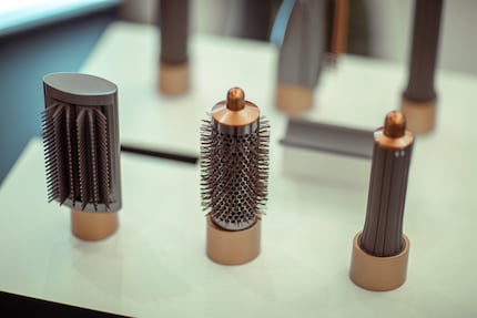 The improved attachments for the Dyson Airwrap from left to right: smoothing brush, round brush and curling attachment.