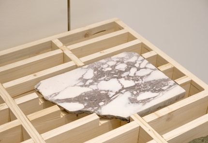 The regular, monochrome grid structure makes the unique pieces stand out even more.