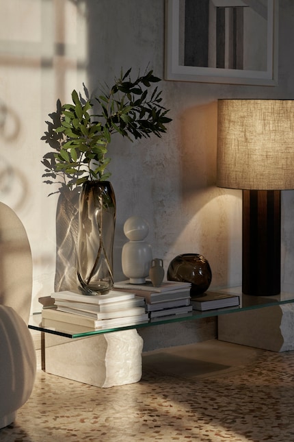 Piles of books stand out even more with a bit of greenery.