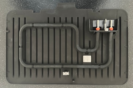 A look at the back of a grill plate shows the plug and the heating coil which heat the plate evenly.