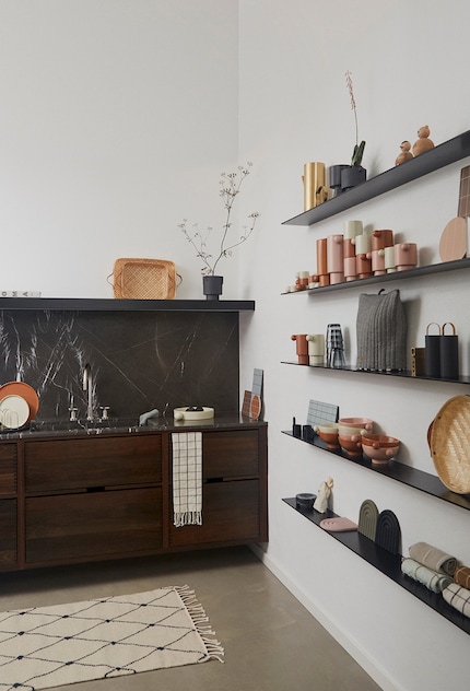 These shelves are mounted on two walls and offer as much storage space as a conventional shelving unit.