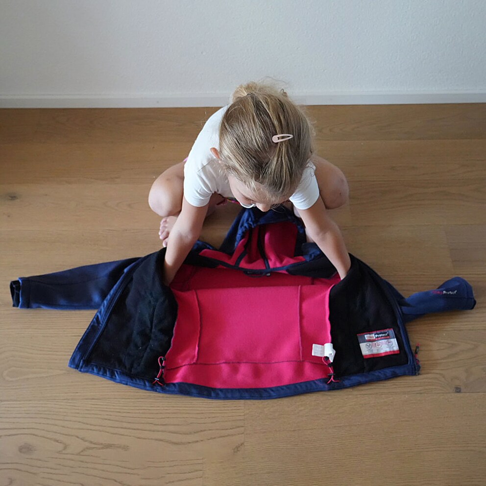 Slip into the jacket from the top, ...
