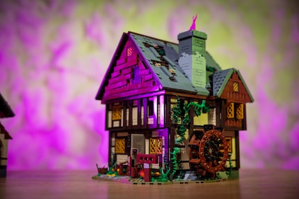 If you spin the water wheel, pink smoke will puff from the chimney.