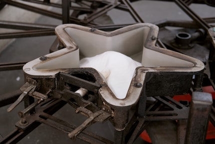 A mould is built to match each design. This is then inserted into the machine and pushed into the oven.