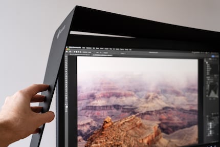 The magnetic light protection panel snaps onto the sides of the monitor. Very useful.