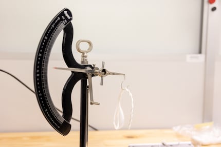 Ueli uses a 19th-century scale to check the diameter of the thread.