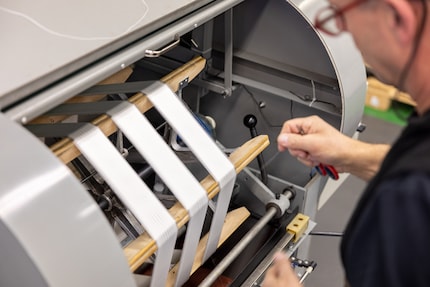 A machine neatly lines up the threads.