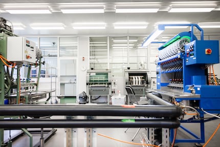 Numerous machines and lots of manual work turn cocoons into silk.