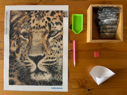 The kit contains everything I need for my masterpiece. I also made a funnel out of paper to make it easier to tip the diamonds back into the bags.