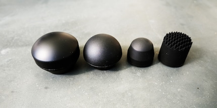 The various attachments of the Theragun Sense: dampener, standard ball, thumb, micro-point.