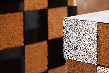 Schachmatt im Wohnzimmer: Das Muster vom Couchtisch «Xadrez» ist von Schachbrettern inspiriert, besteht jedoch aus Kokosfaser, Eierschale, Lack und patiniertem Messing.