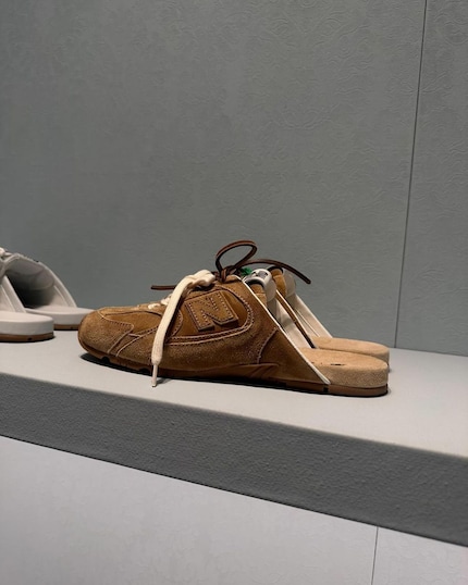 The shoe is half sneaker, half mule.
