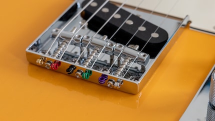 Strings on the bridge plate: works too.