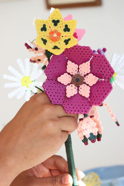 Once you have several flowers ready, you can tie the stems together with the masking tape to make a bouquet.