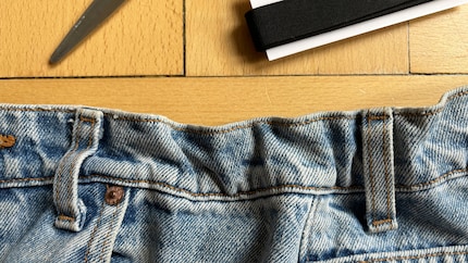 Only the slight gathering of the now tighter waistband is visible from the outside.