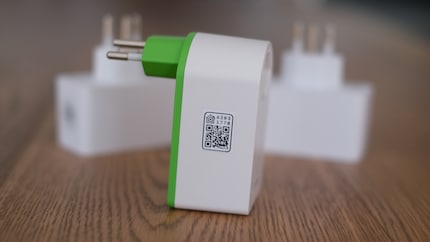 An QR code (like the one pictured) is usually printed on Matter-compatible smart plugs. You can add them to your smart home system by scanning them with your smartphone.