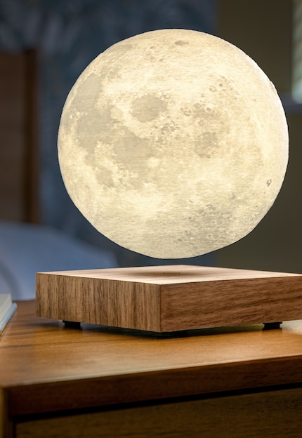 The moon within your grasp: the sphere rotates seemingly weightlessly above the wooden base, just like its real-life counterpart in the sky.