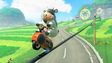A cow on a cassette recorder on a power line. Obviously.