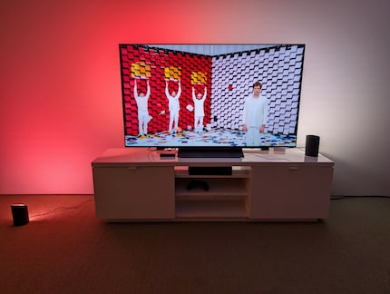 The Philips Hue in action, with one light on the floor and one on the TV stand.